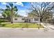 Charming single-story home with a well-maintained lawn, mature trees, and a white picket fence at 504 Holly Ln, Brandon, FL 33510