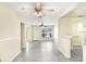 Bright living room with tiled floors, a ceiling fan, and a breakfast bar that connects to the kitchen at 504 Holly Ln, Brandon, FL 33510