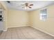 Open living space with tile floors and access to a white kitchen at 504 Holly Ln, Brandon, FL 33510