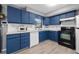 Modern kitchen with blue cabinets and stainless steel appliances at 5243 27Th N Ave, St Petersburg, FL 33710