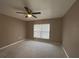 Spacious bedroom with neutral walls and carpet, ceiling fan and window with blinds at 5352 Tangerine Dr, New Port Richey, FL 34652