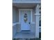 Light blue front door with glass accents and a covered porch at 5352 Tangerine Dr, New Port Richey, FL 34652