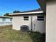 Rear exterior view, showcasing AC unit and windows at 5352 Tangerine Dr, New Port Richey, FL 34652