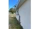 Side view of house exterior with chain link fence at 5352 Tangerine Dr, New Port Richey, FL 34652