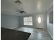 Living room with gray walls, wood-look floors, and an open kitchen concept at 5352 Tangerine Dr, New Port Richey, FL 34652