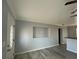 Living room featuring built-in shelving, gray walls, and wood-look floors at 5352 Tangerine Dr, New Port Richey, FL 34652