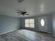 Bright living room with light gray walls, wood-look floors, and a ceiling fan at 5352 Tangerine Dr, New Port Richey, FL 34652