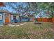 Landscaped backyard with fire pit and wooden fence at 5402 8Th S Ave, Gulfport, FL 33707