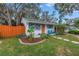 Cute cottage with a fenced yard, stone path, and blue chairs on porch at 5402 8Th S Ave, Gulfport, FL 33707