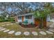 Adorable bungalow with a circular stone path and a fenced yard at 5402 8Th S Ave, Gulfport, FL 33707