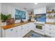 Modern white kitchen with wood countertops and a unique backsplash at 5402 8Th S Ave, Gulfport, FL 33707