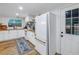 White kitchen with wood countertops, stainless steel appliances, and a view of the backyard at 5402 8Th S Ave, Gulfport, FL 33707