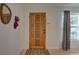 Bright entryway with wood door and geometric rug at 553 Lake Hill Ln, Largo, FL 33771