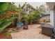 Lush tropical plants surround this brick patio with fire pit at 605 7Th N St, St Petersburg, FL 33701