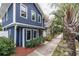 Two-story home with blue siding, white trim, and lush landscaping at 605 7Th N St, St Petersburg, FL 33701