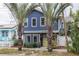 Two-story blue house with white trim, landscaping, and palm trees at 605 7Th N St, St Petersburg, FL 33701