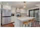 Modern white kitchen with gold accents, large island, and stainless steel appliances at 605 7Th N St, St Petersburg, FL 33701