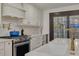 White kitchen with gold fixtures, a farmhouse sink, and stainless steel appliances at 605 7Th N St, St Petersburg, FL 33701