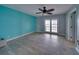 Bedroom with teal accent wall and sliding doors at 6530 Bimini Ct, Apollo Beach, FL 33572