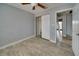 Simple bedroom with grey walls, tile floors, and a double-door closet at 6530 Bimini Ct, Apollo Beach, FL 33572