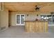 Covered patio with a rustic wooden bar at 6530 Bimini Ct, Apollo Beach, FL 33572