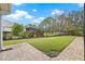 Landscaped backyard with paver patio at 6645 Current Dr, Apollo Beach, FL 33572