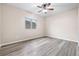 Bedroom with ceiling fan, neutral walls, and wood-look flooring at 6645 Current Dr, Apollo Beach, FL 33572