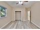 Bright bedroom with ceiling fan, walk-in closet and luxury vinyl plank flooring at 6645 Current Dr, Apollo Beach, FL 33572