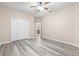 Bedroom with wood-look floors, double door closet, and neutral wall colors at 6645 Current Dr, Apollo Beach, FL 33572