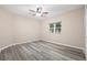 Bright bedroom featuring neutral walls, wood-look flooring and ceiling fan at 6645 Current Dr, Apollo Beach, FL 33572