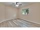 Bedroom with hardwood flooring, ceiling fan, and view to the outside at 6645 Current Dr, Apollo Beach, FL 33572