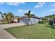 Beautifully maintained home with lush green lawn, mature trees, and a privacy fence, offering a serene outdoor space at 6645 Current Dr, Apollo Beach, FL 33572