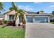 Charming single-story home featuring a two-car garage, beautifully landscaped yard, and classic architectural design at 6645 Current Dr, Apollo Beach, FL 33572