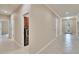 Hallway view into laundry room, with tile flooring and modern appliances at 6645 Current Dr, Apollo Beach, FL 33572