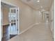 View down a long hallway with doors opening to rooms with contrasting flooring at 6645 Current Dr, Apollo Beach, FL 33572