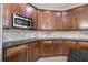 Well-equipped kitchen with dark wood cabinets and granite countertops at 6645 Current Dr, Apollo Beach, FL 33572