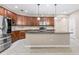 Modern kitchen featuring dark wood cabinets and a large island at 6645 Current Dr, Apollo Beach, FL 33572