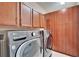 Laundry room with wood cabinets, and a new washer and dryer set at 6645 Current Dr, Apollo Beach, FL 33572