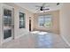 Bright living room with tile flooring, a ceiling fan, and lots of windows at 6645 Current Dr, Apollo Beach, FL 33572