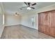 Large living room with hardwood floors, dual fans, and built-in cabinets at 6645 Current Dr, Apollo Beach, FL 33572