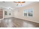 Bright living room featuring wood-look floors and large windows at 6645 Current Dr, Apollo Beach, FL 33572