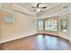 Spacious main bedroom with crown molding, ceiling fan, and lots of windows at 6645 Current Dr, Apollo Beach, FL 33572