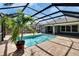 A view of the inviting screened-in pool and patio area with manicured backyard landscaping at 6645 Current Dr, Apollo Beach, FL 33572