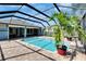 A beautiful screened-in pool with brick pavers is surrounded by lush landscaping at 6645 Current Dr, Apollo Beach, FL 33572