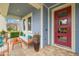 Covered porch with seating area and a red door at 6645 Current Dr, Apollo Beach, FL 33572