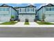 Front view of two attached townhouses with light blue siding, gray roofs, and two-car garages at 7773 93Rd N St # 31, Seminole, FL 33777