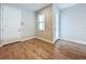 A light-colored hallway with wood flooring and a door leading to another room at 7773 93Rd N St # 31, Seminole, FL 33777