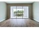 Spacious living room with wood-look floors and sliding doors to patio at 7773 93Rd N St # 31, Seminole, FL 33777