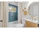 Modern bathroom with teal tile, updated vanity, and gold fixtures at 803 E North St, Tampa, FL 33604