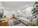 Bright and airy living room with light gray sectional sofa and wood flooring at 803 E North St, Tampa, FL 33604